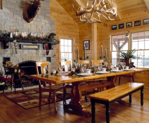 dining room table in holiday themed log home, timberhaven log homes, log homes, log cabin kits, log cabins, Merry Christmas, stone fireplace, fireplace in dining room, natural light, white pine